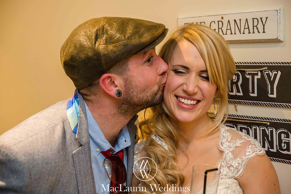 a guest giving the bride a kiss on the cheek
