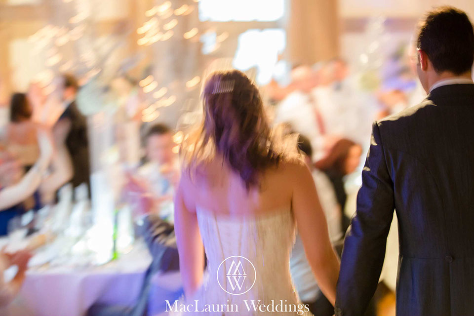 wedding couple entering the reception