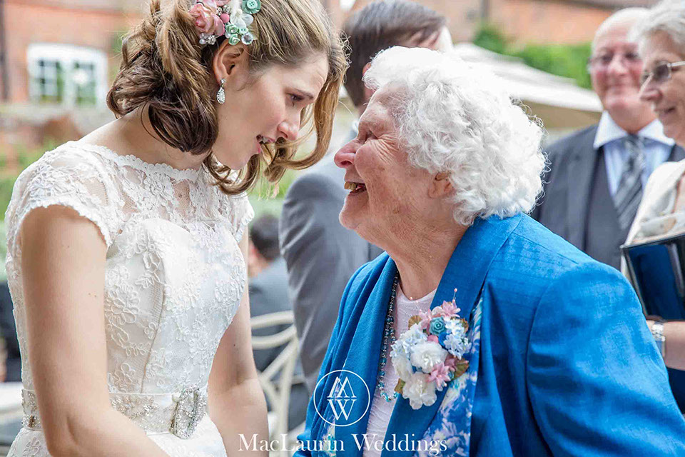a documentay wedding photograph capturing a bride with her grandmother during the receiving line