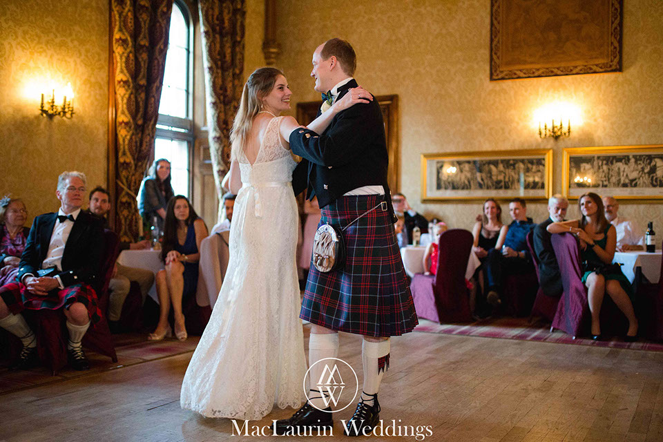 a happy bride and groom during their first dance at dalhousie castle scotland