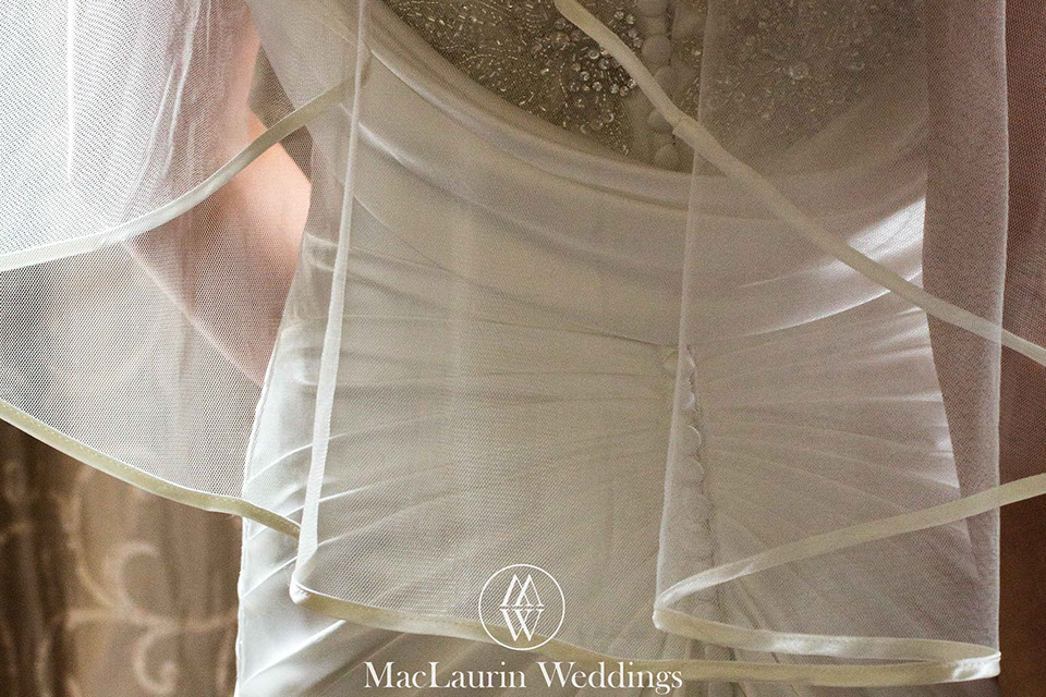 a detail photograph of a brides dress