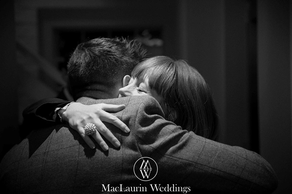 a lovely hug for the groom from one of the guests