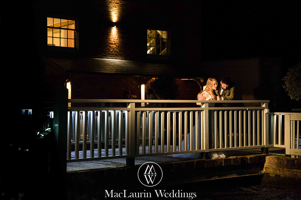 a relaxed pose of the bride and groom at night