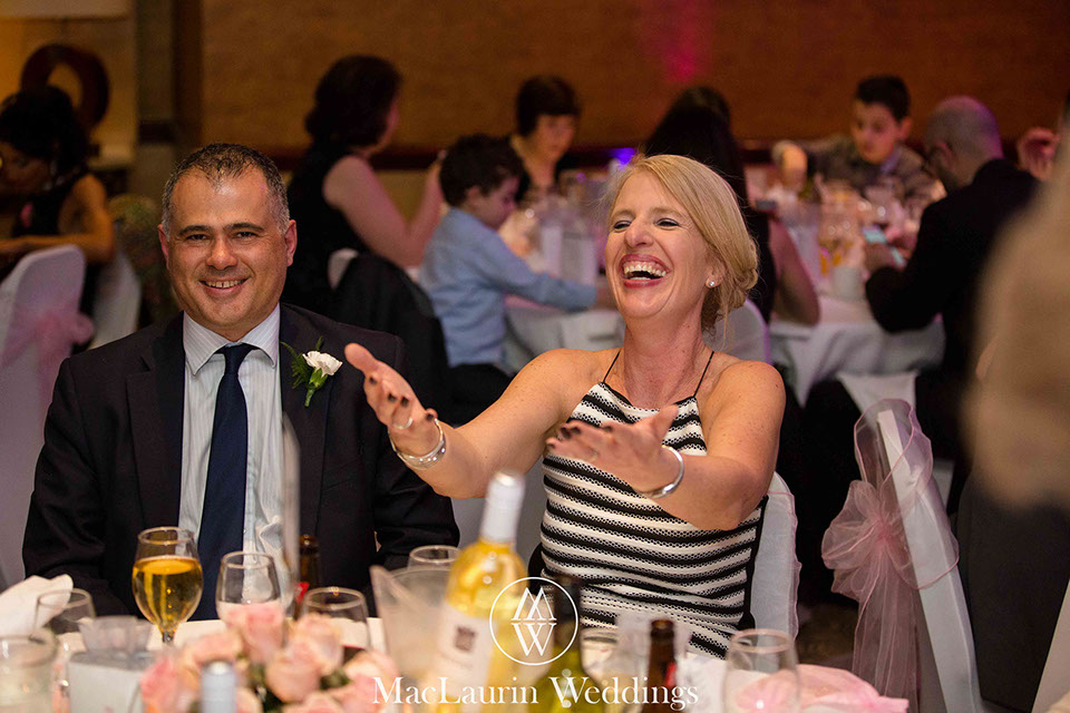 a laughing wedding guest at wedding breakfast