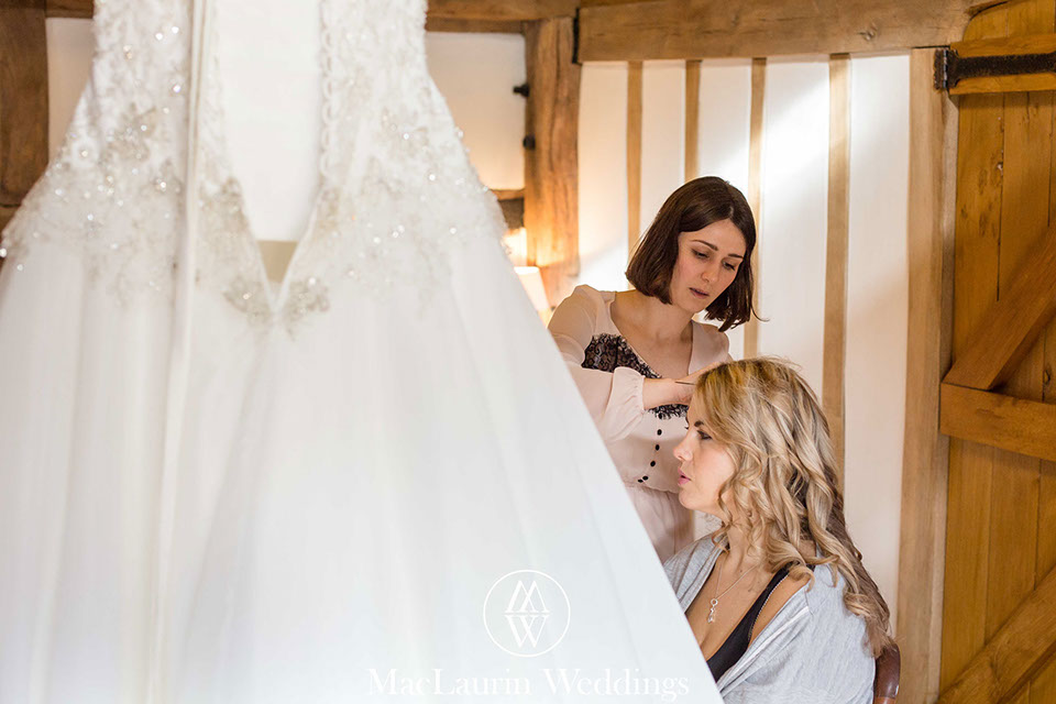hairstylist styling hair before the wedding 