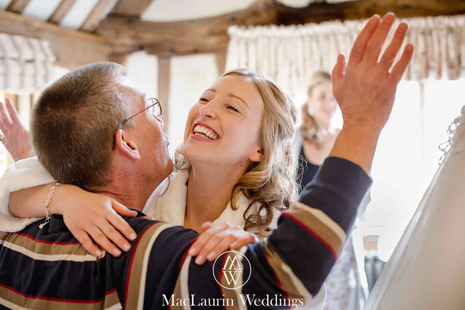 father and bride embrasing before wedding