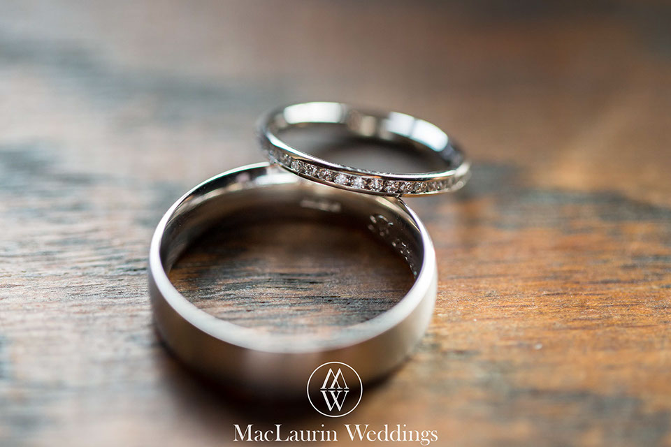 a close up of engagement and wedding ring