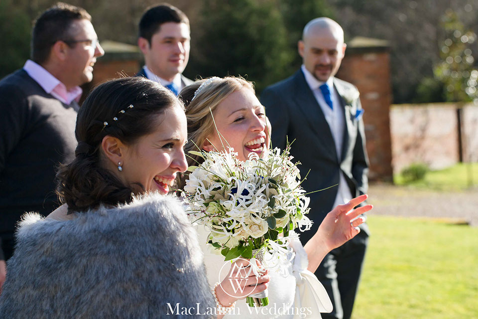 A bride laughing with her guests 